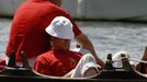 A Queen's Swan Upper sits in the sun during the annual Swan Upping ceremony on the River Thames between Shepperton and Windsor in southern England July 15, 2013. Young c