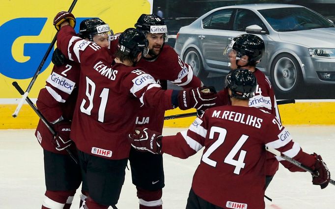 Latvia's Kaspars Daugavins (C) celebrates his goal against Finland with team mates during the first period of their men's ice hockey World Championship group B game at Mi