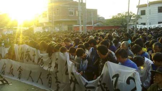Vesničané drží minutu ticha za Süe Ťin-poa.