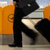A passenger walks past a ticket counter of German air carrier Lufthansa at Berlin Tegel airport