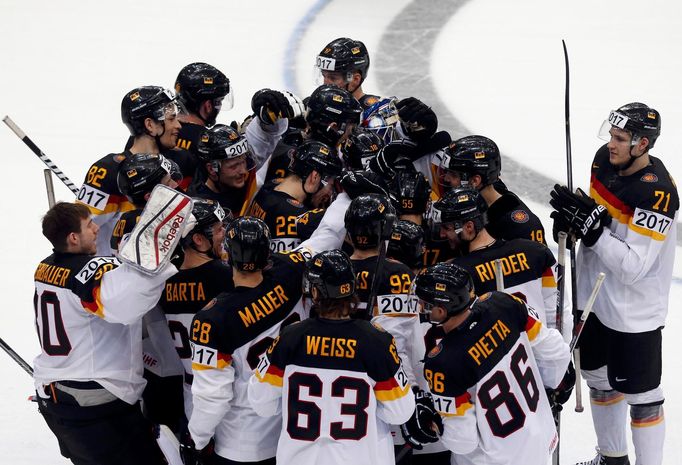 Germany's players celebrate after their men's ice hockey World Championship Group B game against Kazakhstan at Minsk Arena in Minsk May 10, 2014. Reuters/Alexander Demian