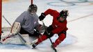 REFILE - QUALITY REPEAT - Switzerland's Phoebe Stanz controls the puck in front of goaltender Janine Alder (L) during their ice hockey women's team training session at th