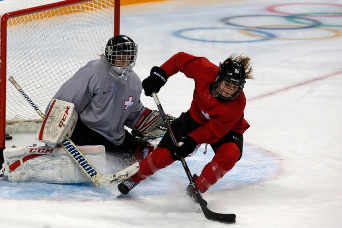 REFILE - QUALITY REPEAT - Switzerland's Phoebe Stanz controls the puck in front of goaltender Janine Alder (L) during their ice hockey women's team training session at th