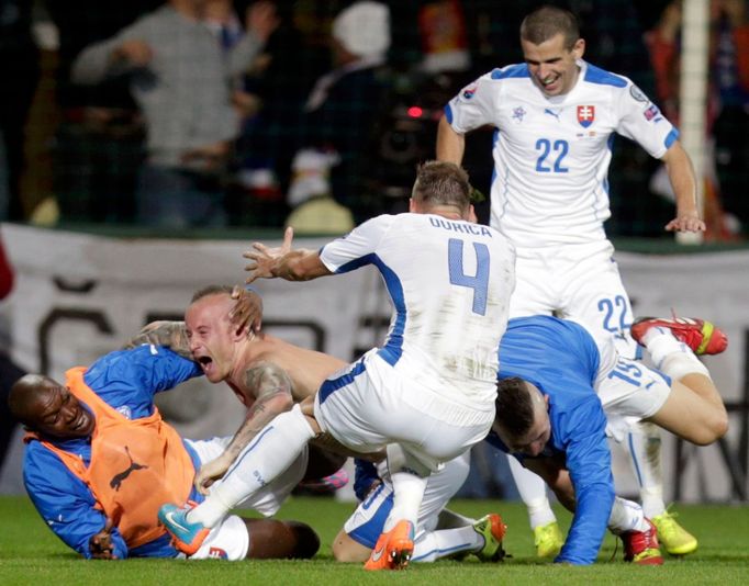 Stoch of Slovakia celebrates his goal against Spain with team mates during their Euro 2016 qualification soccer match at the MSK stadium in Zilina