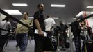 Luis Salgado, nicknamed Chucho, holds his passport as he waits in line at U.S. Immigration, upon arriving at Miami airport on a direct flight from Havana, March 13, 2013. Chucho was granted a U.S. visa based on his father's status as legal resident in Texas, and he was reunited in Miami with his father, Jesus Salgado, who had escaped Cuba on a frail boat ten years earlier. The Salgados are among many Cubans taking advantage of Cuba's new travel policy in place since last January, which allows citizens to leave the country with just a passport and no need for much-hated exit visas required since 1961. Picture taken March 13, 2013. REUTERS/Desmond Boylan (UNITED STATES - Tags: POLITICS SOCIETY) Published: Dub. 11, 2013, 1:21 odp.