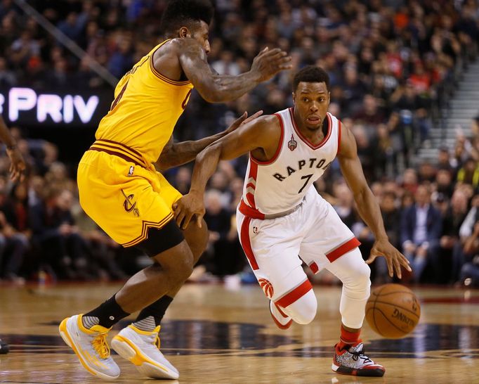 Toronto Raptors guard Kyle Lowry (7) dribbles the ball around Cleveland Cavaliers guard Iman Shumpert (4) at the Air Canada Centre.