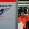 A pit crew of Marussia, which Formula One driver Jules Bianchi of France belongs to, wipes his face as he cleans up the pit after the Japanese F1 Grand Prix at the Suzuka Circuit