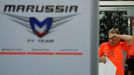 A pit crew of Marussia, which Formula One driver Jules Bianchi of France belongs to, wipes his face as he cleans up the pit after the Japanese F1 Grand Prix at the Suzuka