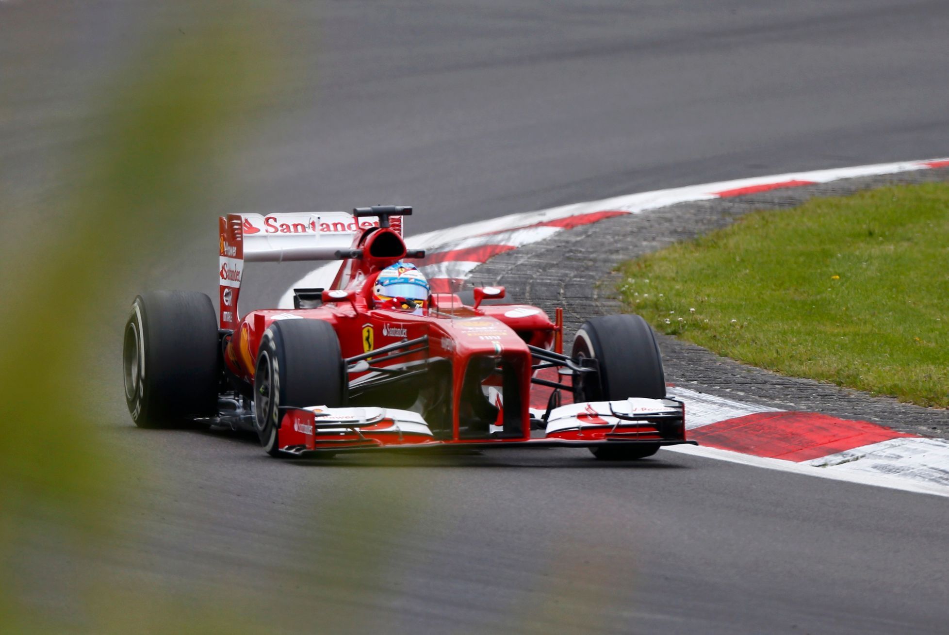 Ferrari Formula One driver Alonso takes corner during second