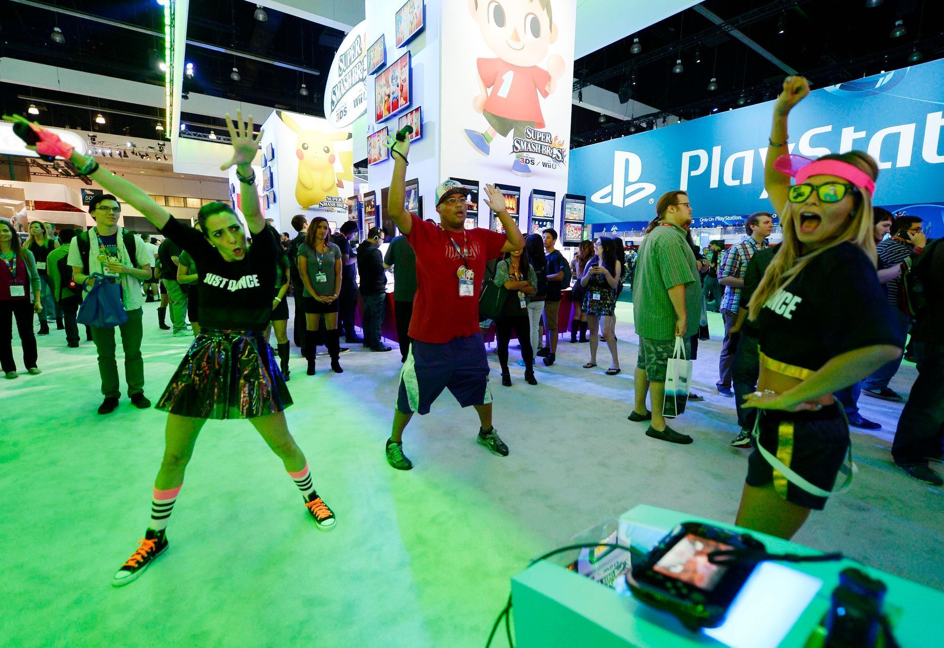 Ubisoft employees Jen Galassao (L), Kelly Koski (R) and attendee Joh Yamamoto play &quot;Just Dance 2015&quot;, a game for the Wii U and Wii, at the Nintendo booth at the 2014 Electronic Entertainment
