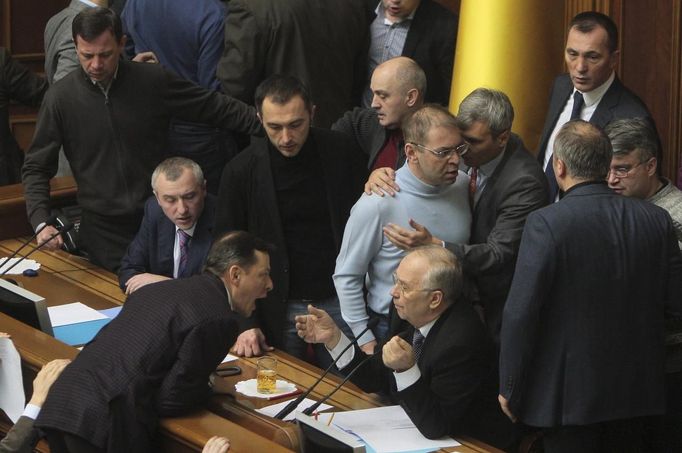 Ukrainian deputies surround speaker Volodymyr Rybak (C, bottom) during a session of parliament in Kiev February 21, 2014. Fighting broke out between deputies in Ukraine's