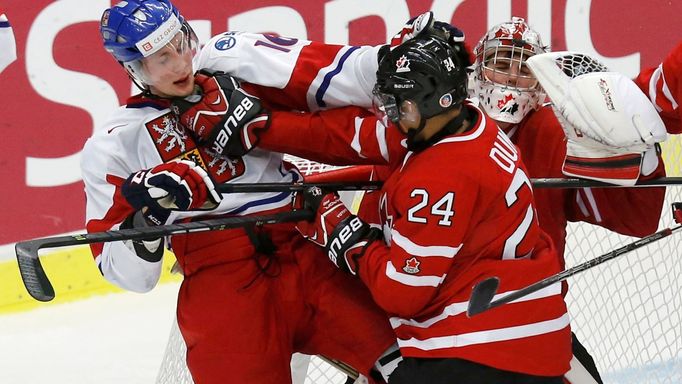 Canada's Dumba battles with Czech Republic's Faksa in front of Canada's goalie Paterson during the third period of their IIHF World Junior Championship ice hockey game in