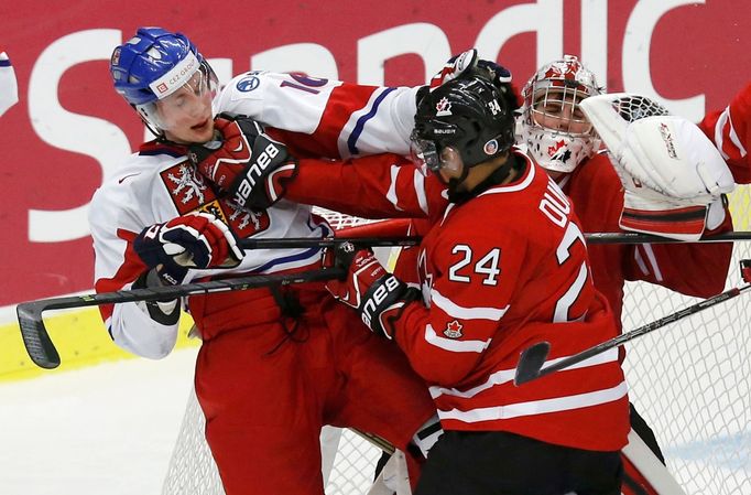 Canada's Dumba battles with Czech Republic's Faksa in front of Canada's goalie Paterson during the third period of their IIHF World Junior Championship ice hockey game in