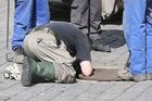 Sticking his head in all the manholes around the Hradčanské Square - that is a job of a fireworker clearing the area of possible bombs.