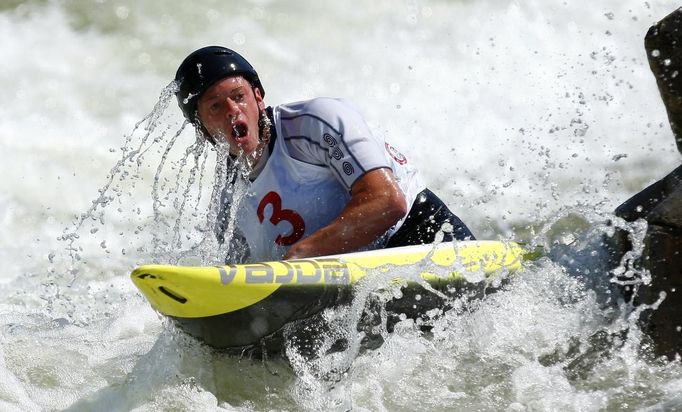 Tyler Hinton takes a breath after going under the water while competing in the men's C1 during the U.S. Olympic trials for whitewater slalom in Charlotte