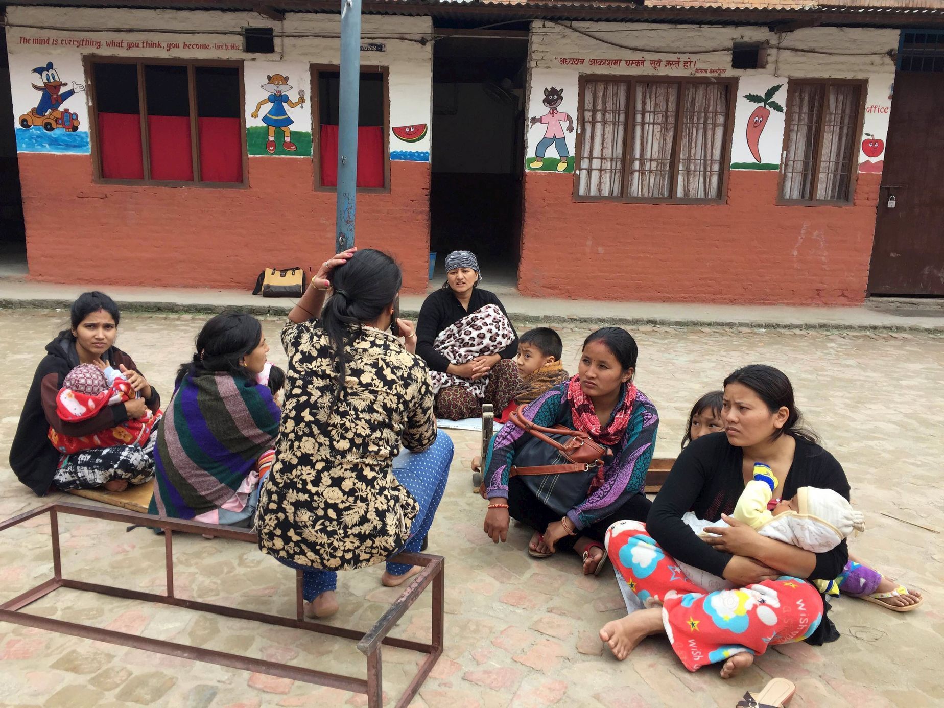 People take refuge at a school after a 7.7 magnitude earthquake struck in Kathmandu