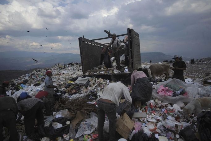 Garbage collectors look for recyclable waste at a municipal dump site in Tegucigalpa