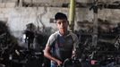 MIDEAST-GAZA-CHILD-LABOR (130604) -- Gaza, June 4, 2013 -- A Palestinian boy works at a garage for repairing cars in Gaza city on June 4, 2013. Many boys left school to work in many different jobs to support their families. Child labor is widespread in the Gaza Strip because of the high rates of poverty.