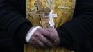 A priest holds a crucifix at a barricade in Kiev February 21, 2014.