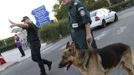 Security personnel stand with a dog after an explosion at Bulgaria's Burgas airport July 18, 2012. An explosion which killed six people and injured dozens of Israeli tourists at the Bulgarian airport of Burgas was caused by a bomb in their bus, Bulgarian Foreign Minister Nikolai Mladenov told Reuters by telephone. In a statement, the foreign ministry said five people were killed and one died later in hospital. Thirty two people were taken to hospital with injuries. REUTERS/Nikolay Doncev (BULGARIA - Tags: DISASTER TRANSPORT)