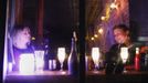 Women sit in a bar lit by candlelight in the Lower East Village in the aftermath of Hurricane Sandy in New York October 31, 2012. New York City and the sodden U.S. Northeast began an arduous journey back to normal on Wednesday after mammoth storm Sandy killed at least 64 people in a rampage that swamped coastal cities and cut power to millions. REUTERS/Carlo Allegri (UNITED STATES - Tags: SOCIETY ENVIRONMENT DISASTER FOOD) Published: Lis. 1, 2012, 3:42 dop.