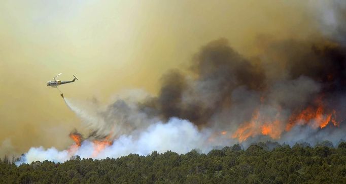 A fire fighting helicopter drops water over the Wood Hollow fire, north of Fairview, Utah, June 26, 2012. More than 500 structures have been threatened by the Wood Hollow fire, forcing up to 1,500 people from homes. REUTERS/George Frey (UNITED STATES - Tags: ENVIRONMENT DISASTER TPX IMAGES OF THE DAY) Published: Čer. 26, 2012, 9:17 odp.