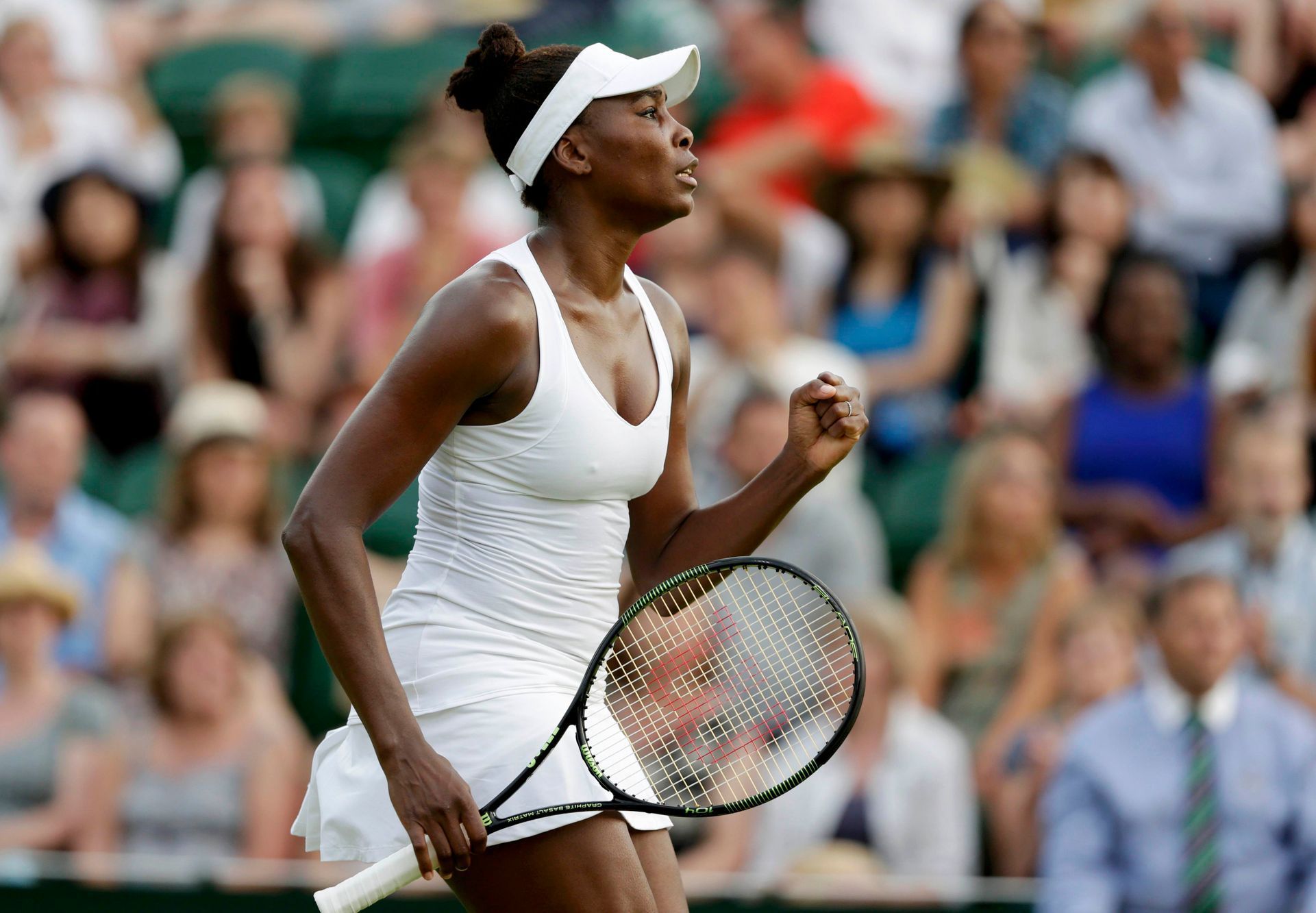 Venus Williams of the U.S.A. celebrates after winning the first set during her match against Yulia Putintseva of Kazakhstan at the Wimbledon Tennis Championships in London