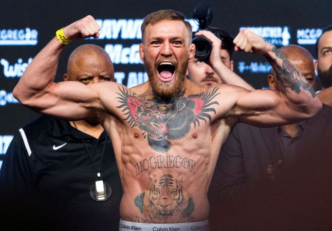 FILE PHOTO: UFC lightweight champion Conor McGregor of Ireland poses on the scale during his official weigh-in at T-Mobile Arena in Las Vegas, Nevada, U.S., August 25, 20