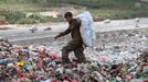 A boy collects recyclable items at a garbage disposal site near Sanaa