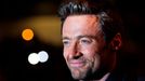 Hugh Jackman poses with fans as he arrives for the "Prisoners