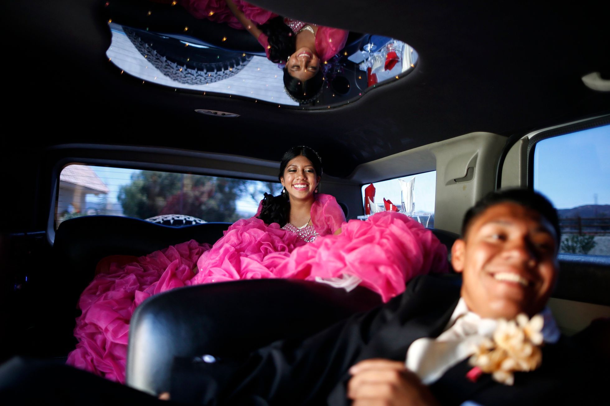 Mimi Pineda, whose parents are from El Salvador, rides to church in a limousine with her friend Christian Flores during her quinceanera in Santa Clarita