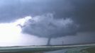 Alfalfa OK, 22 May 1981, looking NNW. A "textbook" tornado extending from the wall cloud of a classic supercell, with a "clear slot" cutting through the cloud base around the near side of the wall cloud. The slot represents part of the occlusion downdraft, an arc of sinking air believed to contribute to tornado development in many cases. The tornado did damage rated at F2.