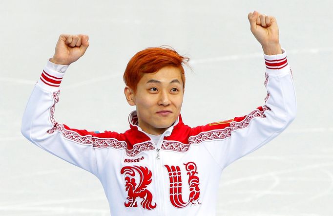 Russia's Victor An celebrates his bronze medal finish in the men's 1,500 metres short track speed skating finals event at the Iceberg Skating Palace during the 2014 Sochi