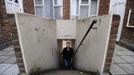 George Kapetanios walks up steps towards his flat in Potters Bar, on the outskirts of London