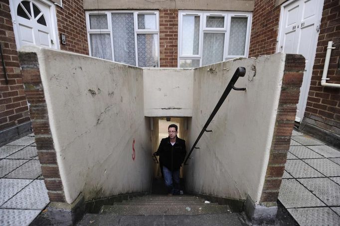 George Kapetanios walks up steps towards his flat in Potters Bar, on the outskirts of London