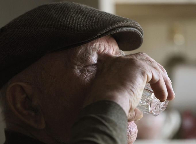 Villager Shamianok drinks vodka during his breakfast in his house at abandoned village of Tulgovichi