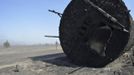 A tank lies on its side, burnt by the so-called Dump Fire, just outside an explosives plant near Saratoga Springs, Utah, June 23, 2012. A raging Utah brush fire ignited by target shooting in dry grass has forced some 8,000 people from their homes in two small communities since June 22 as high winds fanned flames toward a nearby explosives factory, authorities said. REUTERS/Jeff McGrath (UNITED STATES - Tags: ENVIRONMENT DISASTER) Published: Čer. 24, 2012, 1:56 dop.