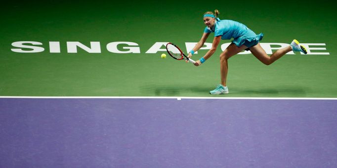 Petra Kvitova of the Czech Republic hits a return to Agnieszka Radwanska of Poland during their WTA Finals singles tennis match at the Singapore Indoor Stadium October 21