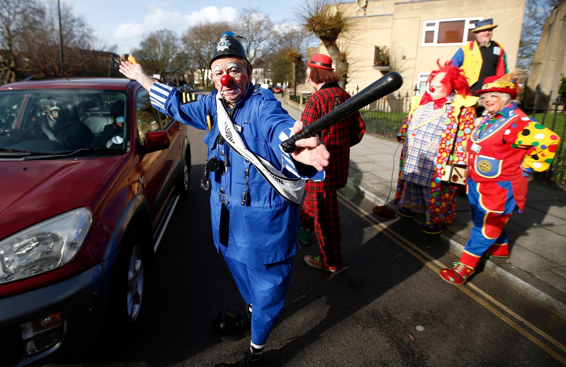 The clown &quot; PC Konk&quot; pretends to direct traffic outside the All Saints Church before the Grimaldi clown service in Dalston, north London