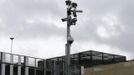 A pole of security cameras is seen outside the Olympic Athletes Village at the Olympic Park in Stratford, the location of the London 2012 Olympic Games, in east London July 16, 2012. The first wave of Olympic athletes and visitors began pouring into Britain on Monday and officials played down fears that a packed London would buckle under the pressure of its biggest peacetime security and transport operation. An embarrassing shortage of security guards, fears over airport queues and questions about the capital's creaking transport system have overshadowed preparations for the Games. REUTERS/Suzanne Plunkett (BRITAIN - Tags: SPORT OLYMPICS MILITARY) Published: Čec. 16, 2012, 3:21 odp.