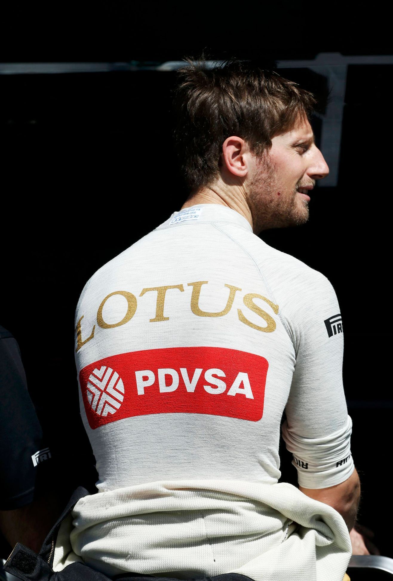 Lotus Formula One driver Romain Grosjean of France looks on during the first practice session of the Australian F1 Grand Prix at the Albert Park circuit in Melbourne