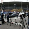 Media stand behind a barrier in front of the Stade de France stadium the morning after a series of deadly attacks in Paris