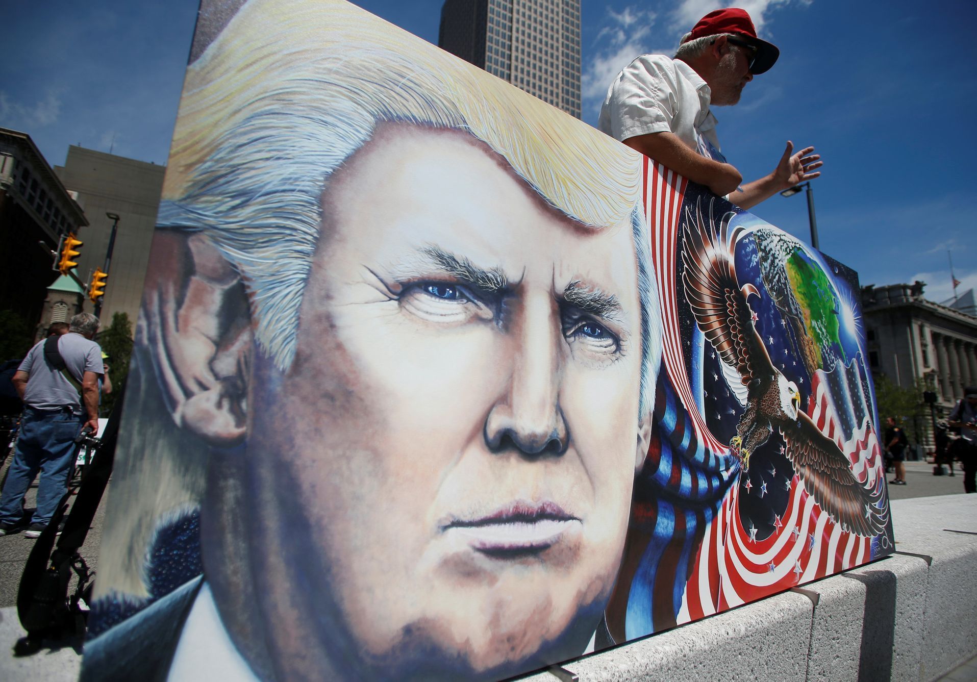 Julian Raven, a supporter of Republican Presidential Candidate Donald Trump, holds his artwork at the Public Square in Cleveland, Ohio, U.S.