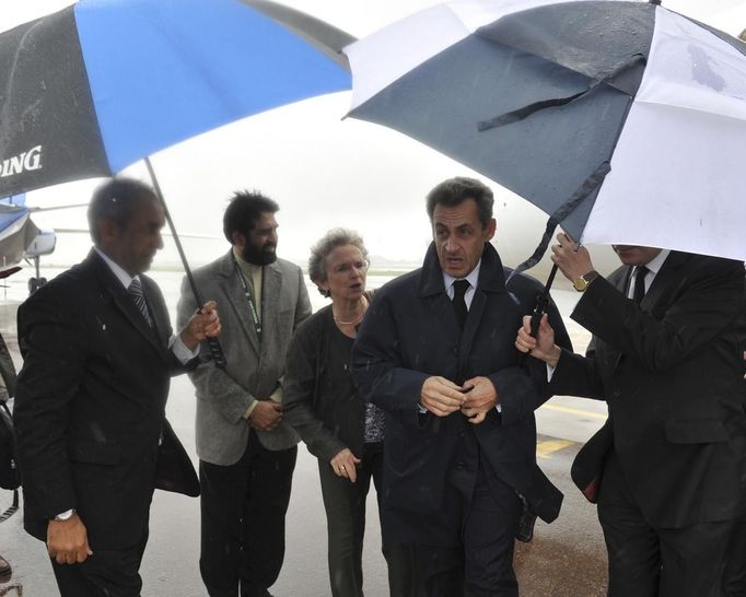 Former French President Nicolas Sarkozy (2nd R) arrives at Air Force Base Waterkloof, Pretoria December 10, 2013, in this handout picture provided by the South African Government Communication and Information System (GCIS).