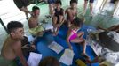 Children with disabilities receive instructions before attending a "Bototherapy" session at Arau River in Amazon August 22, 2012. The "Bototherapy", a "Rolfing" therapeutic practice assisted by river dolphins, was developed by Igor Andrade, a physiotherapist, and the treatment is free for children with disabilities or disorders from low income families. Picture taken August 22, 2012. REUTERS/Bruno Kelly (BRAZIL - Tags: SOCIETY HEALTH) Published: Srp. 28, 2012, 1:44 dop.