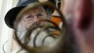 A participant is seen through the moustache of a fellow competitor as he helps him to get ready for the 2012 European Beard and Moustache Championships in Wittersdorf near Mulhouse, Eastern France, September 22, 2012. More than a hundred participants competed in the first European Beard and Moustache Championships organized in France. REUTERS/Vincent Kessler (FRANCE - Tags: SOCIETY) Published: Zář. 22, 2012, 7:25 odp.