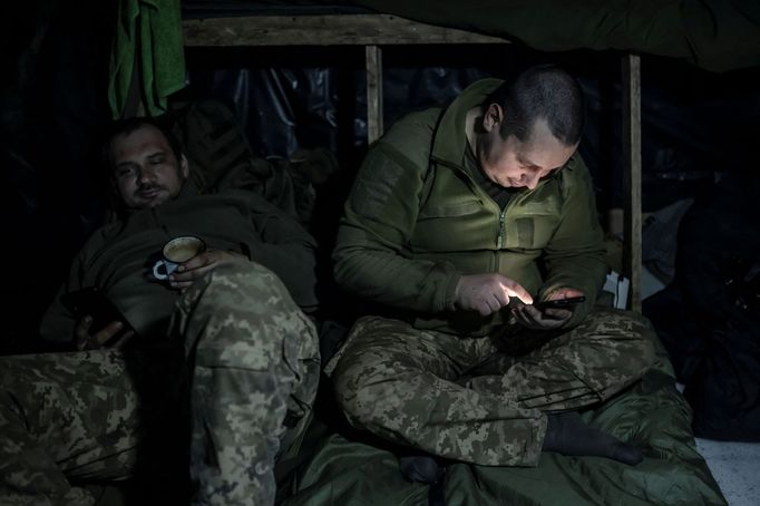 Ukrainian service members rest inside a dugout at a position near the front-line town of Bakhmut, amid Russia's attack on Ukraine, in Donetsk region, Ukraine December 21,