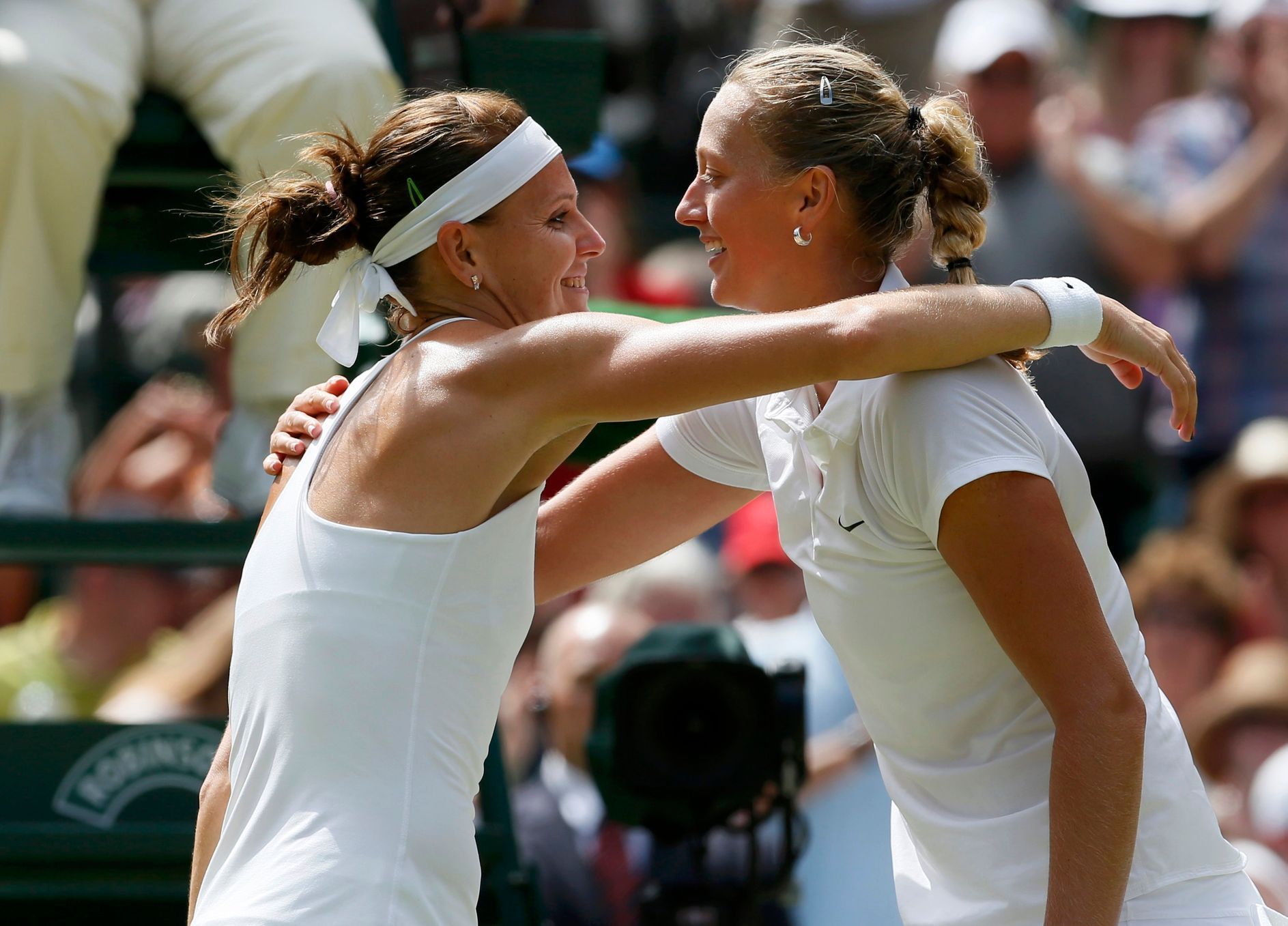 Petra Kvitova of the Czech Republic embraces Lucie Safarova of the Czech Republic after defeating her in their women's singles semi-final tennis match at the Wimbledon Tennis Championships, in London