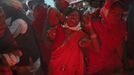 A man holds a devotee who is believed to be possessed by evil spirits as she goes into a state of trance at Guru Deoji Maharaj temple during a ghost fair at Malajpur village in Betul district in the central Indian state of Madhya Pradesh January 26, 2013. People from across India come to this fair to be exorcised of �evil spirits�. They are usually brought by relatives and they are most often women. The exorcism involves running around the temple courtyard to make the 'ghost' weak then being beaten by a priest with a broom. Picture taken January 26, 2013. REUTERS/Danish Siddiqui (INDIA - Tags: SOCIETY RELIGION) ATTENTION EDITORS: PICTURE 22 OF 24 FOR PACKAGE 'INDIAN GHOSTBUSTERS' SEARCH 'INDIA GHOST' FOR ALL IMAGES Published: Úno. 5, 2013, 5:10 dop.