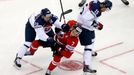 Slovakia's Karol Sloboda (L) and Marek Hrivik (R) knock Canada's Kyle Turris (C) during the first period of their men's ice hockey World Championship group A game at Chiz